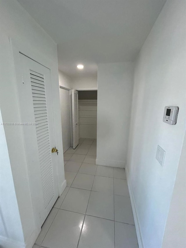 hall with light tile patterned flooring