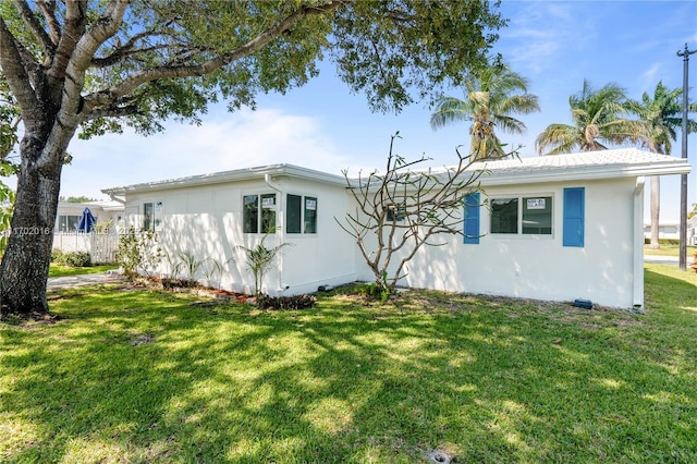 exterior space with a front yard and stucco siding