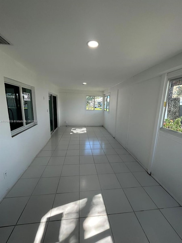 tiled empty room featuring a healthy amount of sunlight