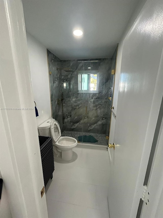 bathroom featuring tile patterned flooring, vanity, toilet, and a shower with shower door