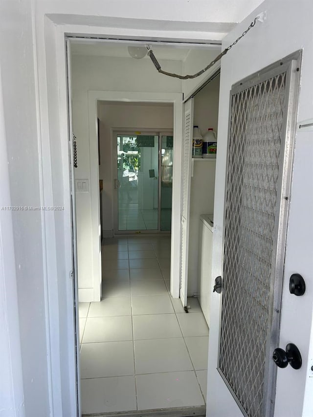 hall featuring light tile patterned floors