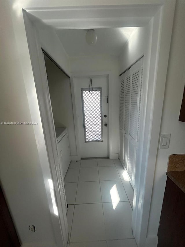 hall featuring light tile patterned floors