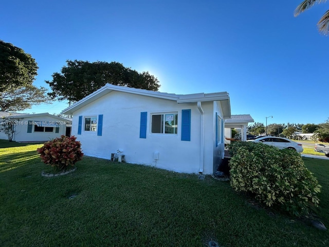 view of side of property with a lawn