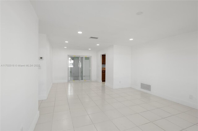 kitchen with dark brown cabinetry, sink, white dishwasher, and light tile patterned flooring