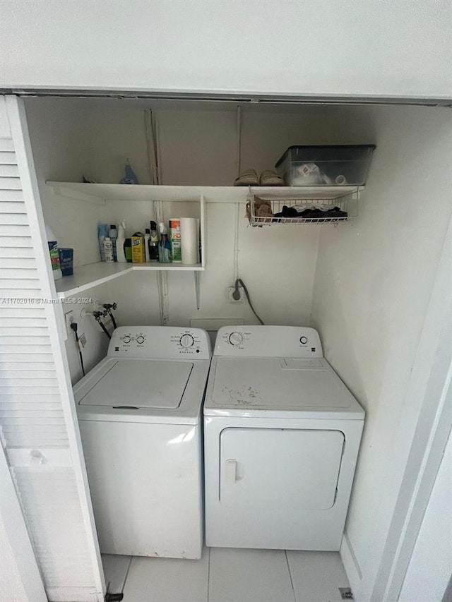 washroom featuring tile patterned flooring and separate washer and dryer