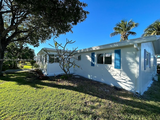 view of property exterior with a lawn