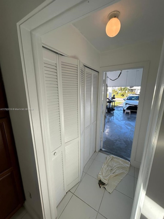 hall featuring light tile patterned floors