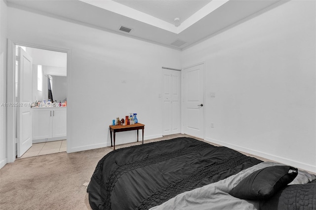 bedroom with light carpet and a closet