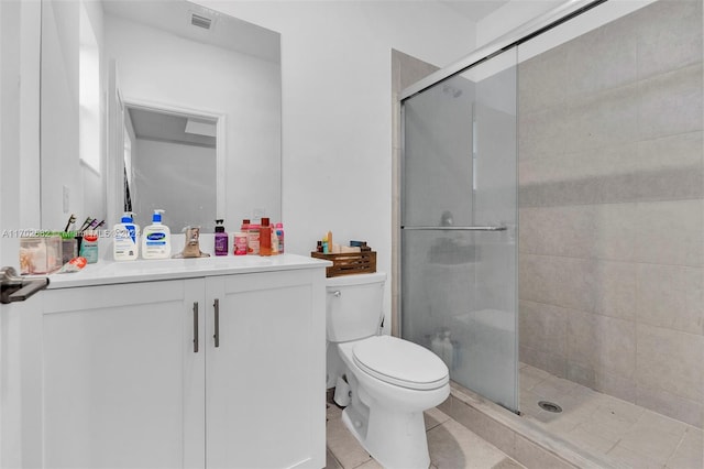 bathroom with tile patterned floors, toilet, an enclosed shower, and vanity