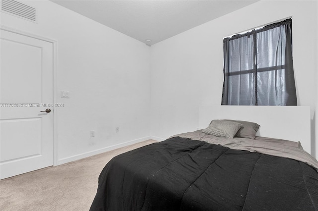 bedroom featuring light colored carpet