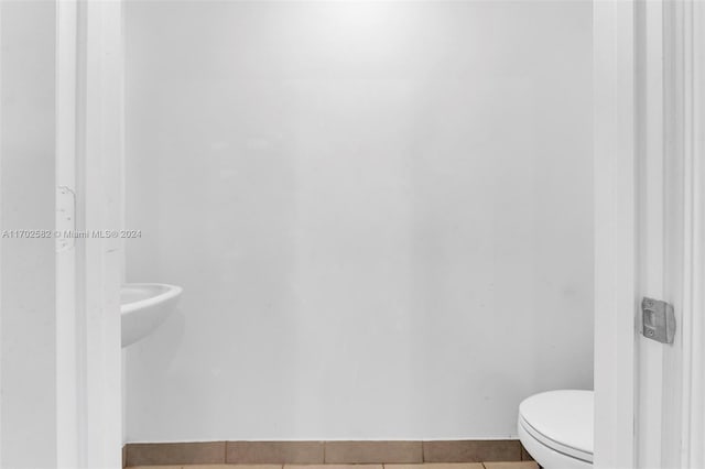 bathroom featuring toilet and tile patterned floors