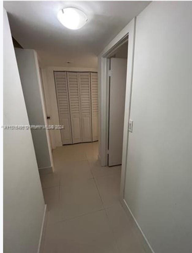 hall featuring light tile patterned floors