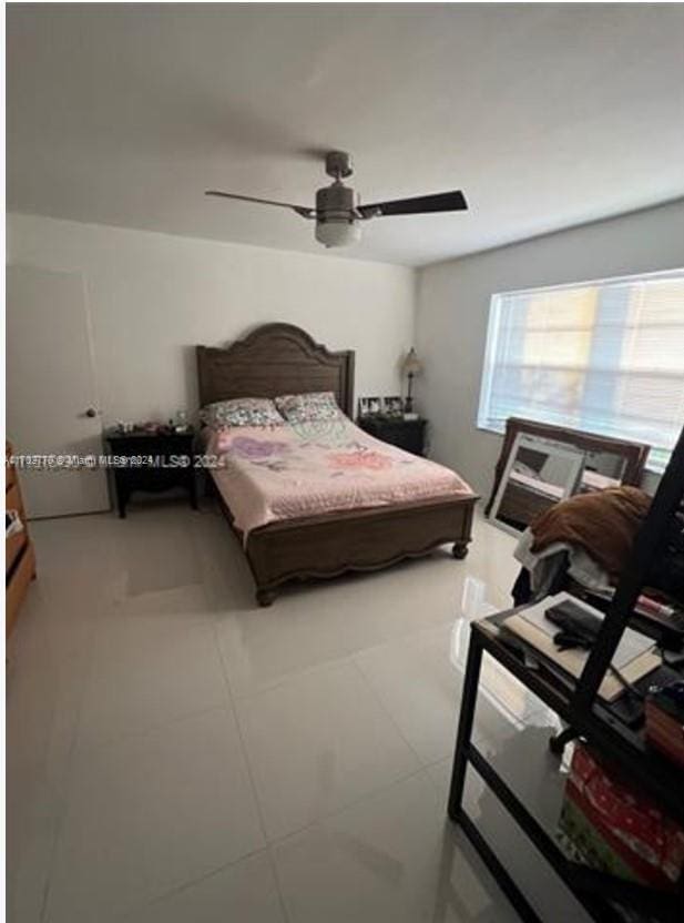 bedroom featuring tile patterned flooring and ceiling fan