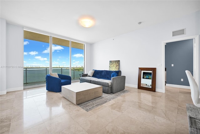 living room featuring expansive windows and a water view