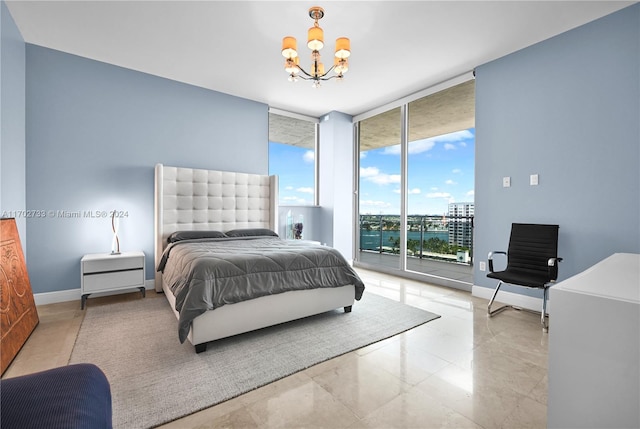 bedroom featuring access to outside, expansive windows, and a chandelier