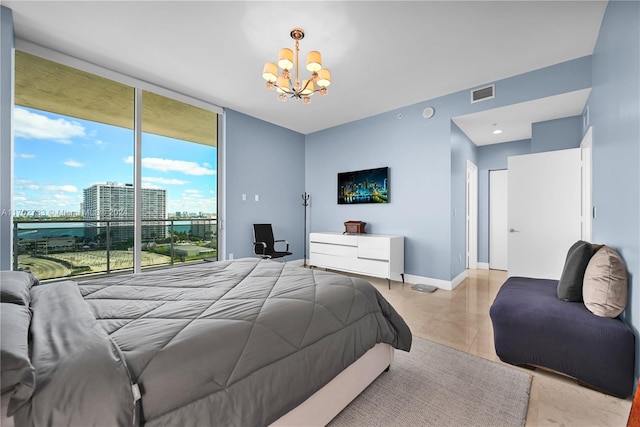 bedroom featuring a wall of windows and a notable chandelier