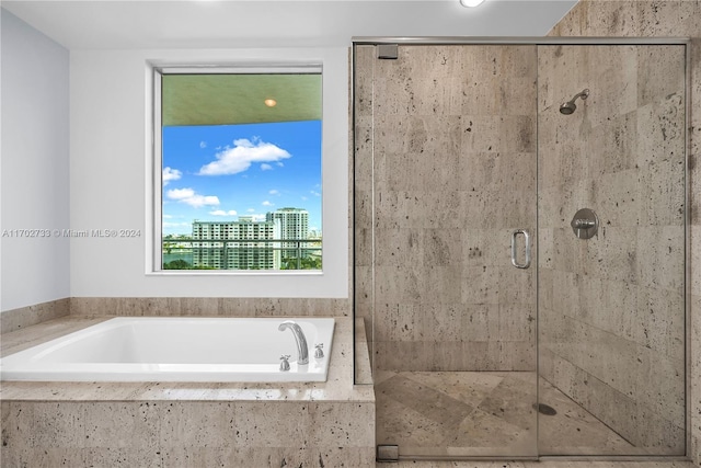 bathroom featuring separate shower and tub