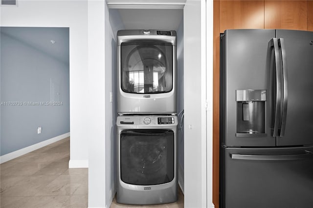 laundry room with stacked washer / dryer