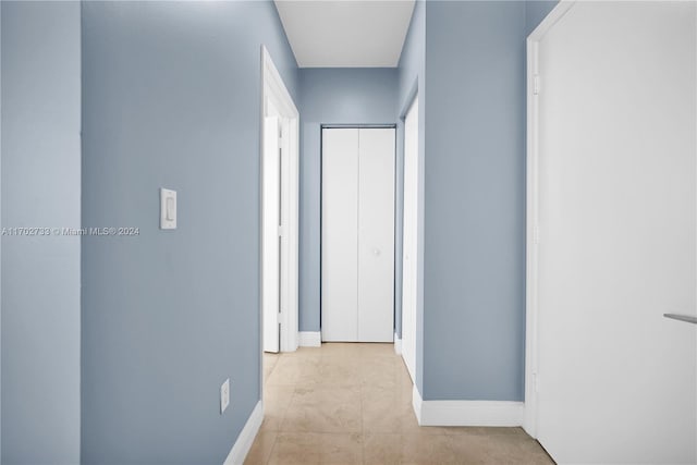 corridor featuring light tile patterned floors