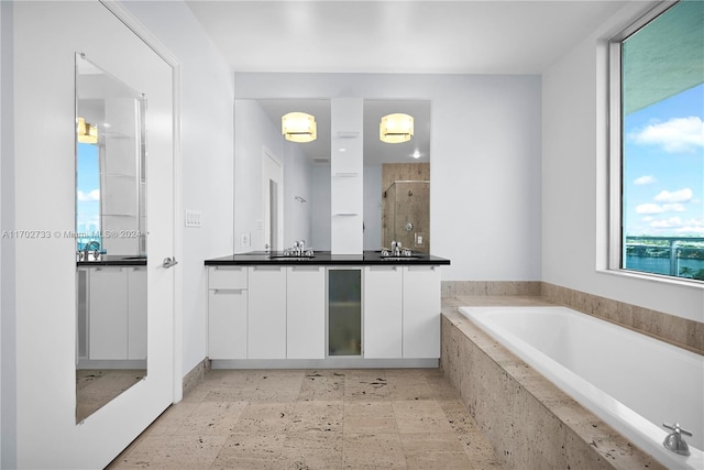 bathroom featuring a water view, vanity, and shower with separate bathtub