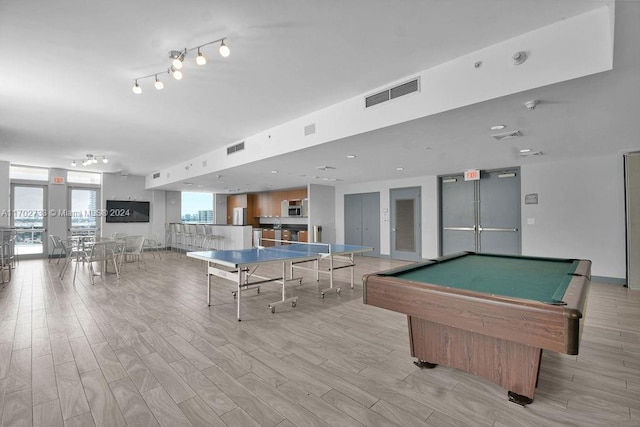 game room with light hardwood / wood-style flooring and pool table