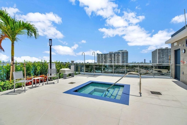 view of swimming pool with a patio and a hot tub