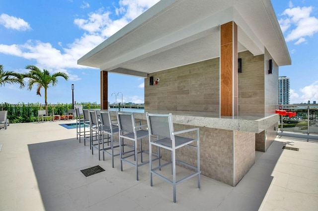 view of patio / terrace featuring an outdoor bar