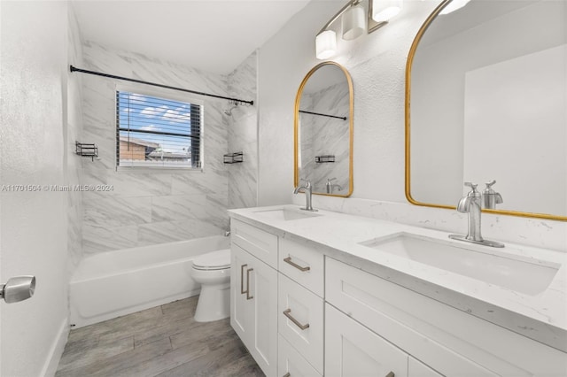 full bathroom with hardwood / wood-style flooring, tiled shower / bath combo, toilet, and vanity