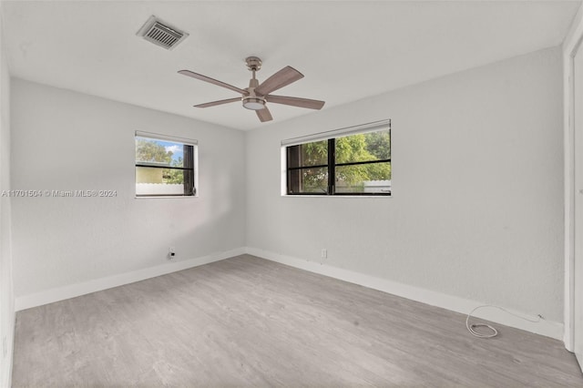 empty room with hardwood / wood-style flooring and ceiling fan