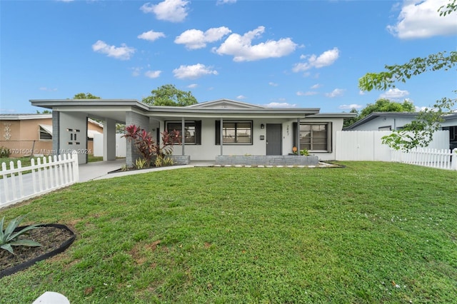 single story home with a front lawn, covered porch, and a carport