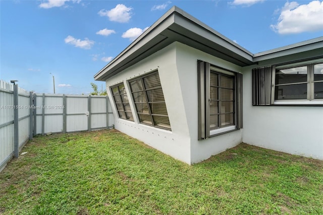 view of property exterior with a yard