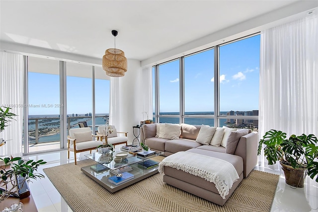 living room with tile patterned flooring and a water view