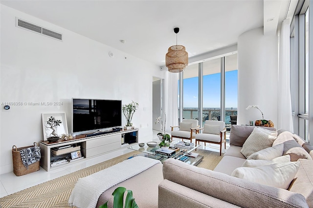 tiled living room with floor to ceiling windows