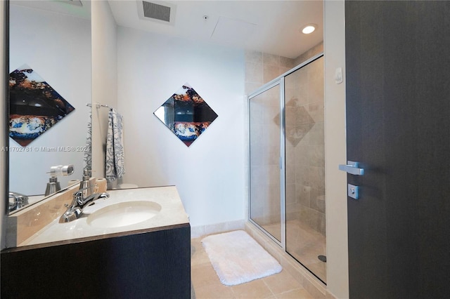 bathroom with tile patterned flooring, vanity, and an enclosed shower