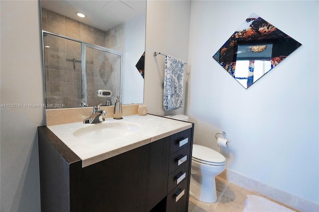 bathroom featuring tile patterned floors, toilet, an enclosed shower, and vanity