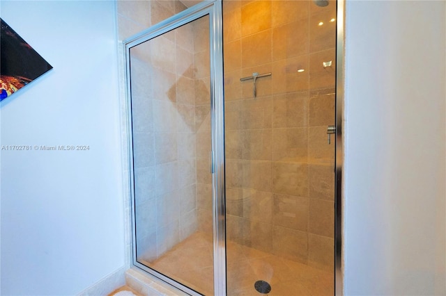 bathroom featuring a shower with shower door