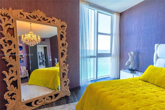 bedroom featuring wood-type flooring and a chandelier