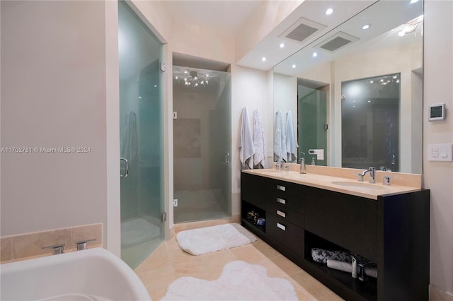 bathroom featuring tile patterned floors, vanity, and shower with separate bathtub