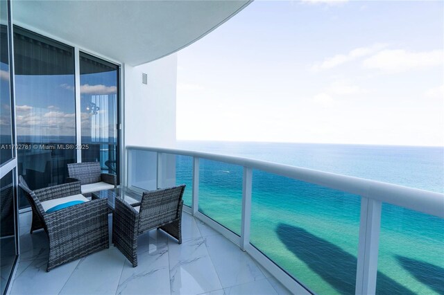 balcony featuring a water view