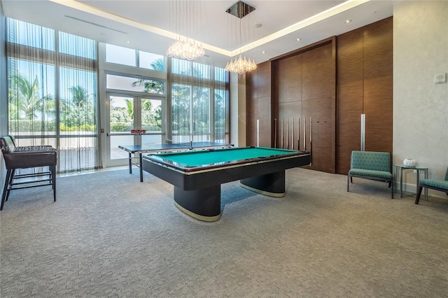 rec room with light colored carpet, a high ceiling, billiards, and an inviting chandelier