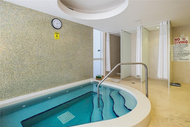 view of swimming pool with an indoor in ground hot tub