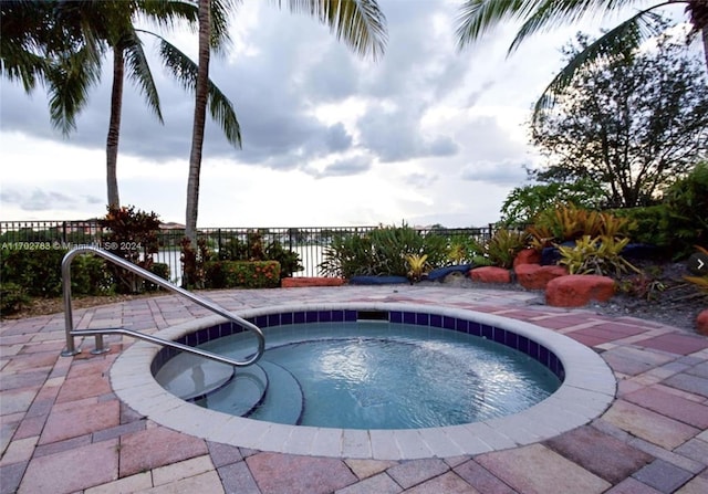 view of pool with an in ground hot tub