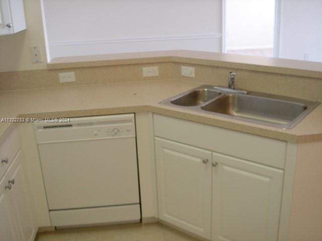 kitchen featuring dishwasher, white cabinets, and sink