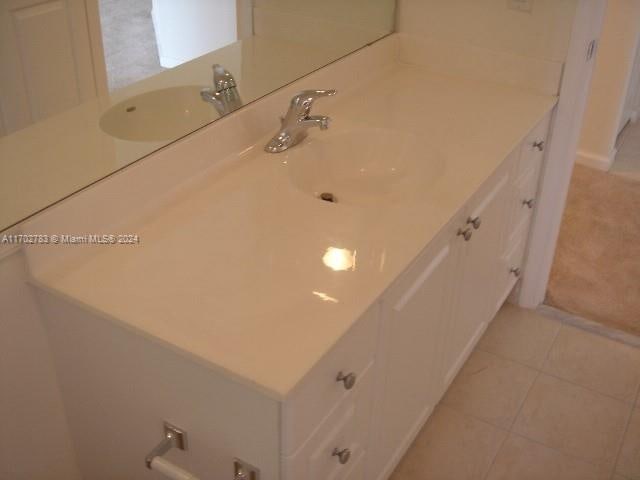 bathroom with tile patterned floors and vanity