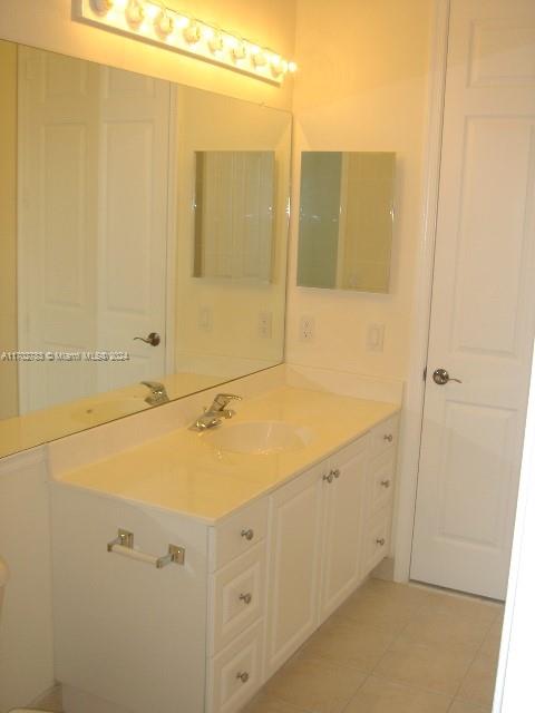 bathroom with tile patterned floors and vanity