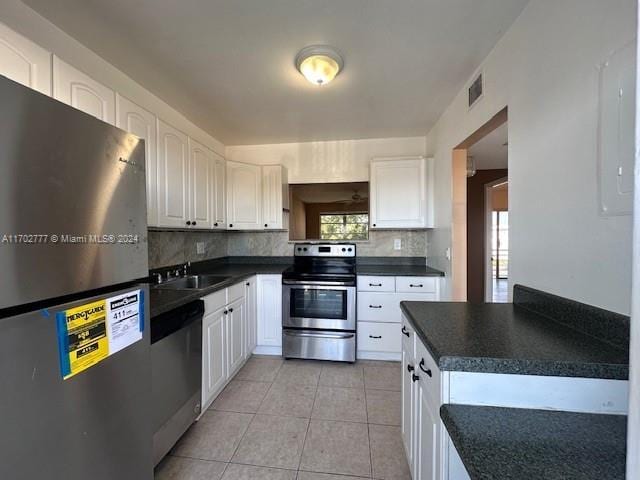 kitchen featuring white cabinets, sink, appliances with stainless steel finishes, and tasteful backsplash