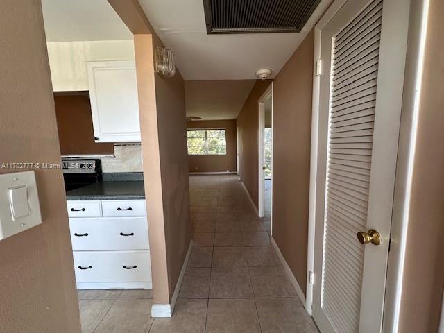 hallway with light tile patterned flooring