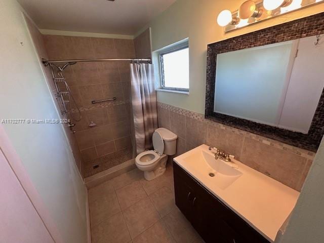 bathroom with tile patterned floors, a shower with curtain, vanity, tile walls, and toilet