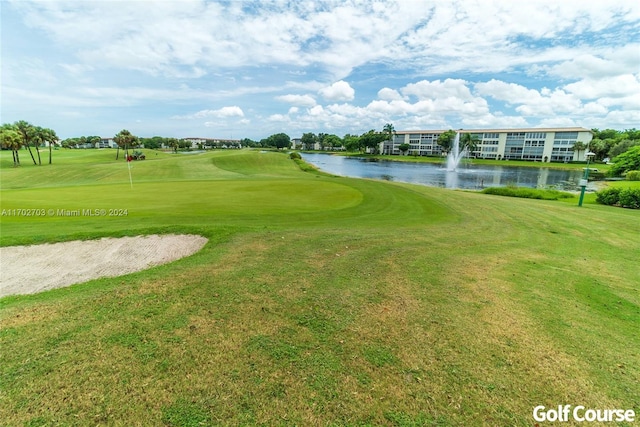 surrounding community featuring a water view and a yard