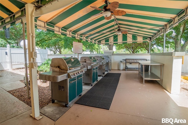 view of patio with a grill, ceiling fan, and exterior kitchen